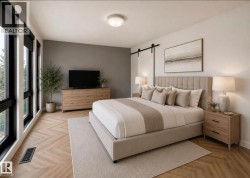Spacious bedroom with extensive window banks, herringbone wood-finish flooring, and a modern barn door hardware installation - 