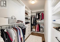 Custom closet organization system featuring white shelving and drawers - 