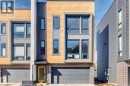 Modern townhome facade featuring a yellow entry door, a two-car garage, and multiple windows across three levels - 1304 Rutherford Road, Edmonton, AB 