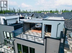 Rooftop patio with checkerboard tile flooring and glass railings - 