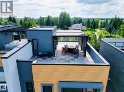 Rooftop patio featuring modern tile flooring, a pergola structure, and surrounding glass railings - 