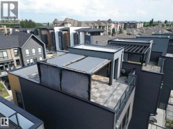 Rooftop patio with patterned tile flooring, a pergola featuring retractable shades, and perimeter glass railing - 