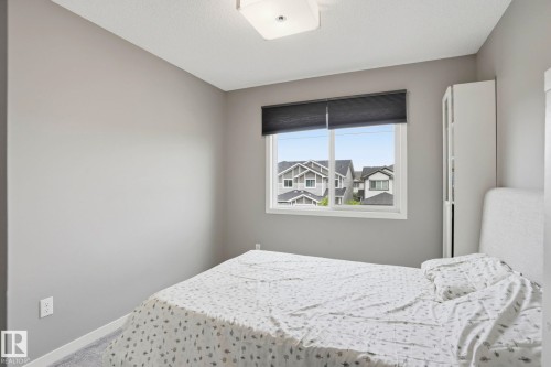 Light gray painted walls with a white trim - 4320 Annett Common, Edmonton, AB - Indoor Photo Showing Bedroom