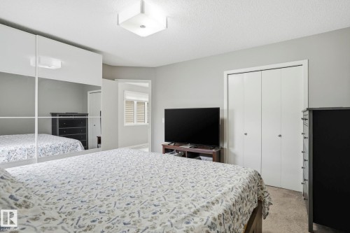 Bedroom featuring mirrored wardrobe doors, light gray wall paint, and plush carpet - 4320 Annett Common, Edmonton, AB - Indoor Photo Showing Bedroom