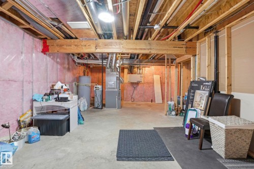 Unfinished basement featuring exposed wood joists and concrete flooring - 4320 Annett Common, Edmonton, AB - Indoor Photo Showing Basement