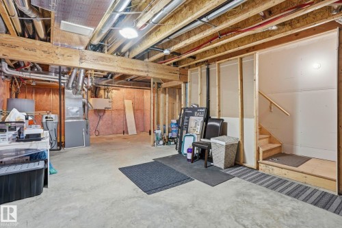 Unfinished basement with exposed ceiling joists and concrete flooring - 4320 Annett Common, Edmonton, AB - Indoor Photo Showing Basement
