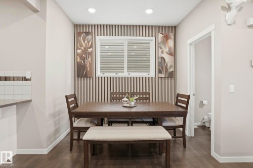 Dining area with a feature slat wall and a window with horizontal blinds - 4320 Annett Common, Edmonton, AB - Indoor Photo Showing Dining Room