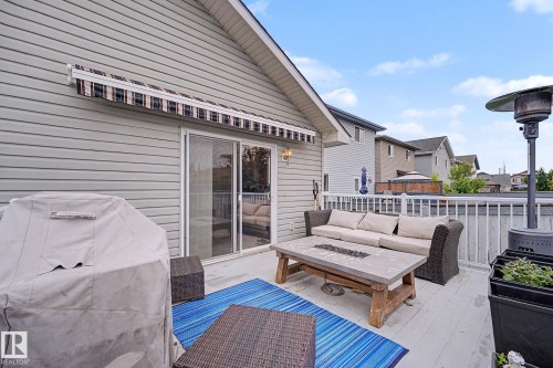 Deck with white railing and sliding glass door - 19039 47 Avenue, Edmonton, AB 