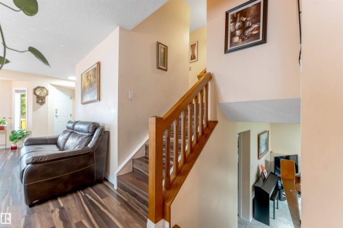 Interior staircase featuring wood-finish treads and a light wood railing - 312 Beringer Crescent, Edmonton, AB 