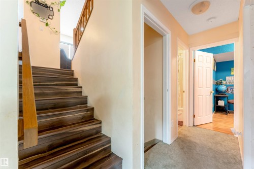 Dark wood-finish staircase with natural wood handrails - 312 Beringer Crescent, Edmonton, AB 