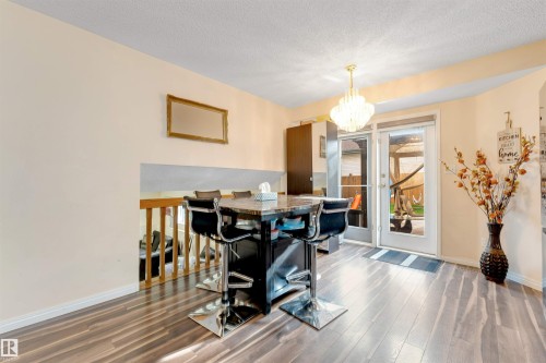 Wood-finish flooring throughout, featuring a crystal chandelier - 312 Beringer Crescent, Edmonton, AB 
