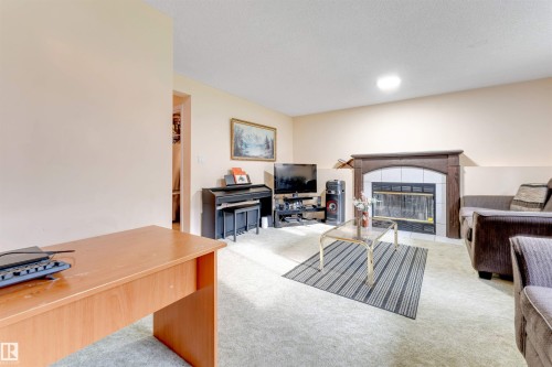 Living area featuring light-toned walls and light-colored carpet - 312 Beringer Crescent, Edmonton, AB 