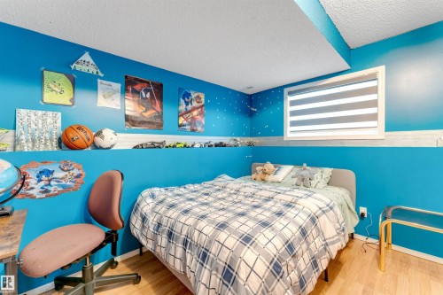 Wood-finish flooring with a contrasting blue and white wall treatment - 312 Beringer Crescent, Edmonton, AB 