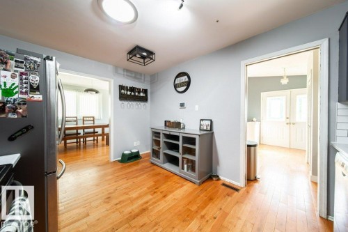 Hardwood flooring extends throughout this space, featuring light gray walls, a skylight, and recessed lighting - 20 Chippewa Rd, Leduc, AB 