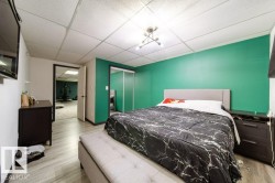 Interior room featuring wood-finish flooring and a drop ceiling with recessed lighting - 
