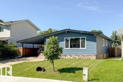Ranch-style residence featuring blue horizontal siding and a stone veneer foundation - 