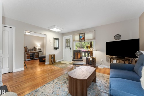 Bright living space featuring wood-finish flooring and neutral wall tones - 5802 172 Street, Edmonton, AB 