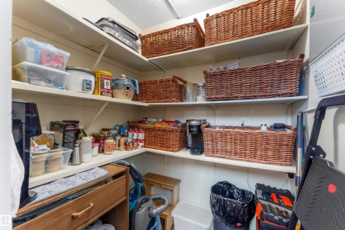 Corner pantry with multiple white shelves for extensive storage - 5802 172 Street, Edmonton, AB 