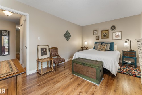 Bedroom featuring wood-finish flooring and neutral wall tones - 5802 172 Street, Edmonton, AB 