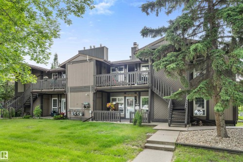 Multi-story exterior with two-tone siding, private balconies, and individual ground-level patios - 5802 172 Street, Edmonton, AB 