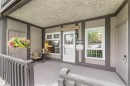 Covered porch featuring painted wood siding, a recessed entry, and a white storm door - 5802 172 Street, Edmonton, AB 