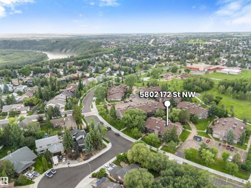 Aerial perspective highlighting a residential area with dense tree coverage and curved roadways - 5802 172 Street, Edmonton, AB 