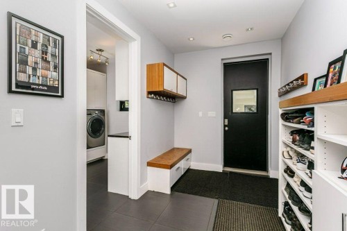 Entryway featuring tile flooring, a built-in bench with storage, and integrated shelving - 9035 Saskatchewan Drive, Edmonton, AB 