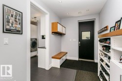 Entryway featuring tile flooring, a built-in bench with storage, and integrated shelving - 