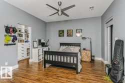 Room featuring wood-finish flooring, a contemporary ceiling fan, recessed lighting, and light gray wall paint - 