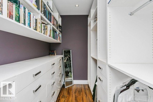 Custom organizational system featuring white cabinetry, integrated shelving, ample drawer storage with polished hardware, and wood-finish flooring - 9035 Saskatchewan Drive, Edmonton, AB 