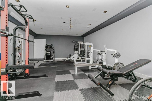 Dedicated fitness room featuring checkerboard rubber flooring - 9035 Saskatchewan Drive, Edmonton, AB 