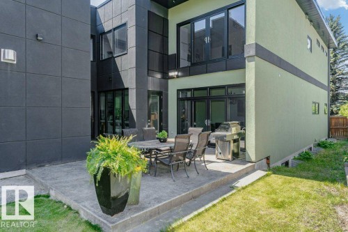 Spacious concrete patio with multi-level design and direct access to the interior - 9035 Saskatchewan Drive, Edmonton, AB 