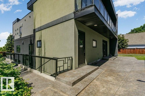 Modern multi-level exterior featuring light green and dark gray stucco finishes - 9035 Saskatchewan Drive, Edmonton, AB 