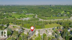 Aerial perspective showcasing a property surrounded by mature trees and verdant parklands - 