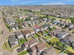 Aerial overview showcasing a residential street with detached homes - 
