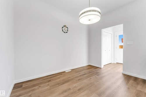 Neutral wall tones defining the space, complemented by wood-finish flooring - 788 Mattson Drive, Edmonton, AB 