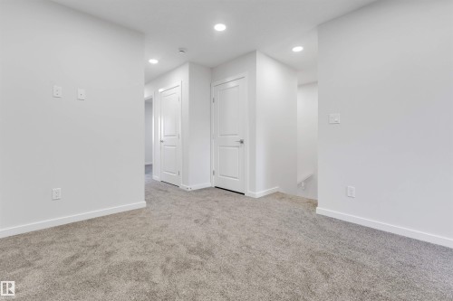 Carpeted hallway featuring recessed lighting, white walls, and white trim - 788 Mattson Drive, Edmonton, AB 