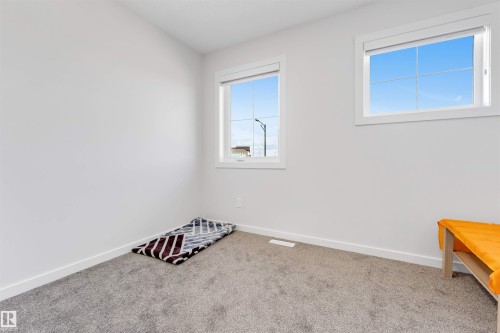 Room featuring two windows with white frames, providing natural light - 788 Mattson Drive, Edmonton, AB 