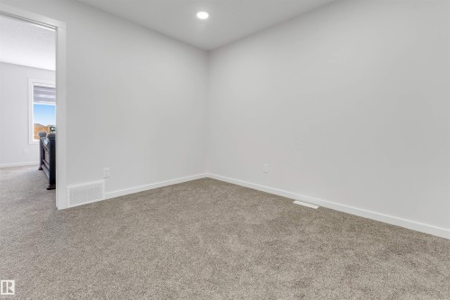 Room featuring plush gray carpeting, white painted walls, and a recessed ceiling light - 788 Mattson Drive, Edmonton, AB 
