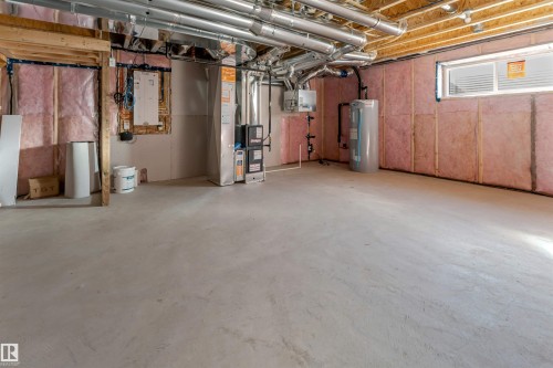 Expansive unfinished basement featuring a concrete floor, exposed wood framing, and pink insulation - 788 Mattson Drive, Edmonton, AB 