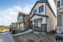 Two-story residence featuring a contrasting light and dark exterior with black trim - 788 Mattson Drive, Edmonton, AB 