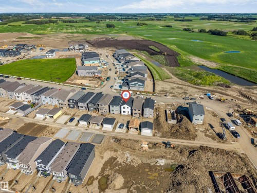 Aerial perspective showcasing a residential development with a row of detached homes and individual garages - 788 Mattson Drive, Edmonton, AB 