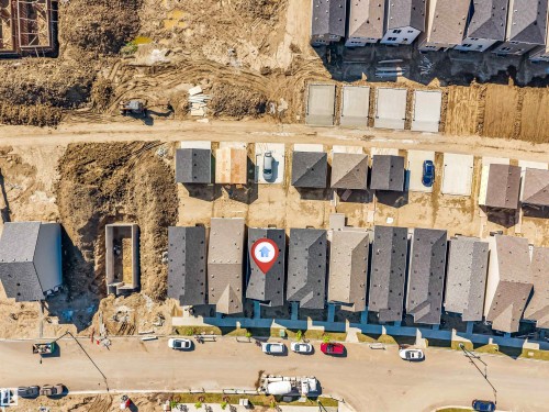 Newly developed community featuring a series of townhome-style residences with dark shingle roofing - 788 Mattson Drive, Edmonton, AB 