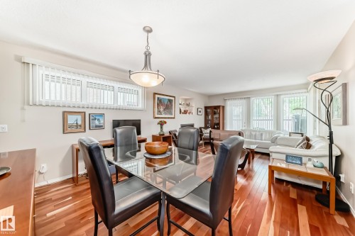 Open-concept living space with wood-finish flooring - 7930 111 Street, Edmonton, AB - Indoor Photo Showing Dining Room