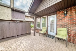 Brick paver patio area with a privacy fence - 