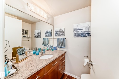 2 piece Bathroom with a light-colored countertop and wood-finish cabinetry - 7930 111 Street, Edmonton, AB - Indoor Photo Showing Bathroom