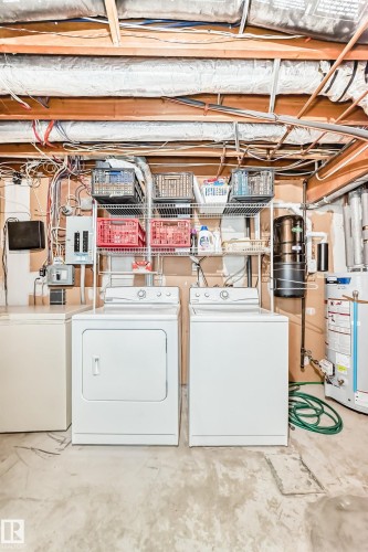 Dedicated laundry area featuring a washer and dryer, adjacent to a utility sink - 7930 111 Street, Edmonton, AB - Indoor Photo Showing Laundry Room