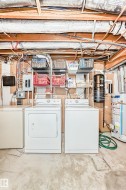 Dedicated laundry area featuring a washer and dryer, adjacent to a utility sink - 