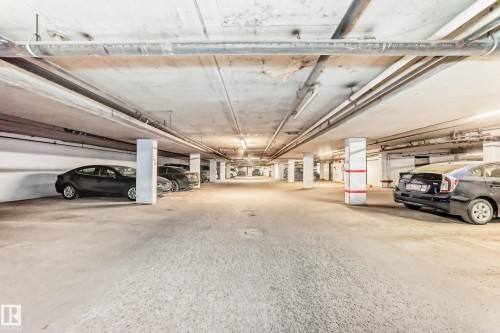 Subterranean parking facility featuring concrete flooring and ceiling - 7930 111 Street, Edmonton, AB - Indoor Photo Showing Garage