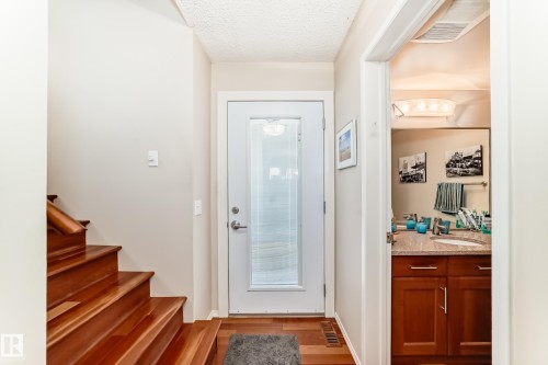 Entryway featuring rich American Cherrywood flooring and a glass-panelled door - 7930 111 Street, Edmonton, AB - Indoor Photo Showing Other Room